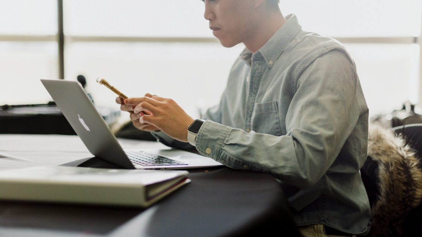 a man sitting in front of a laptop computer