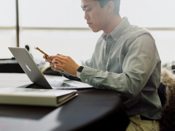a man sitting in front of a laptop computer